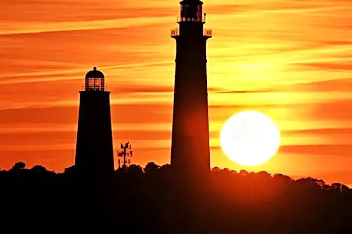 a tower with a sunset in the background