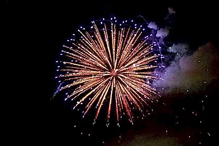 fireworks in the sky with Cosmo Clock 21 in the background