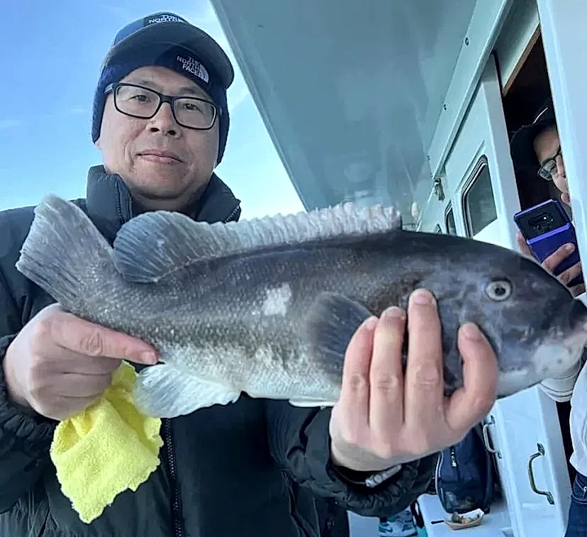 tog24 a man holding a fish