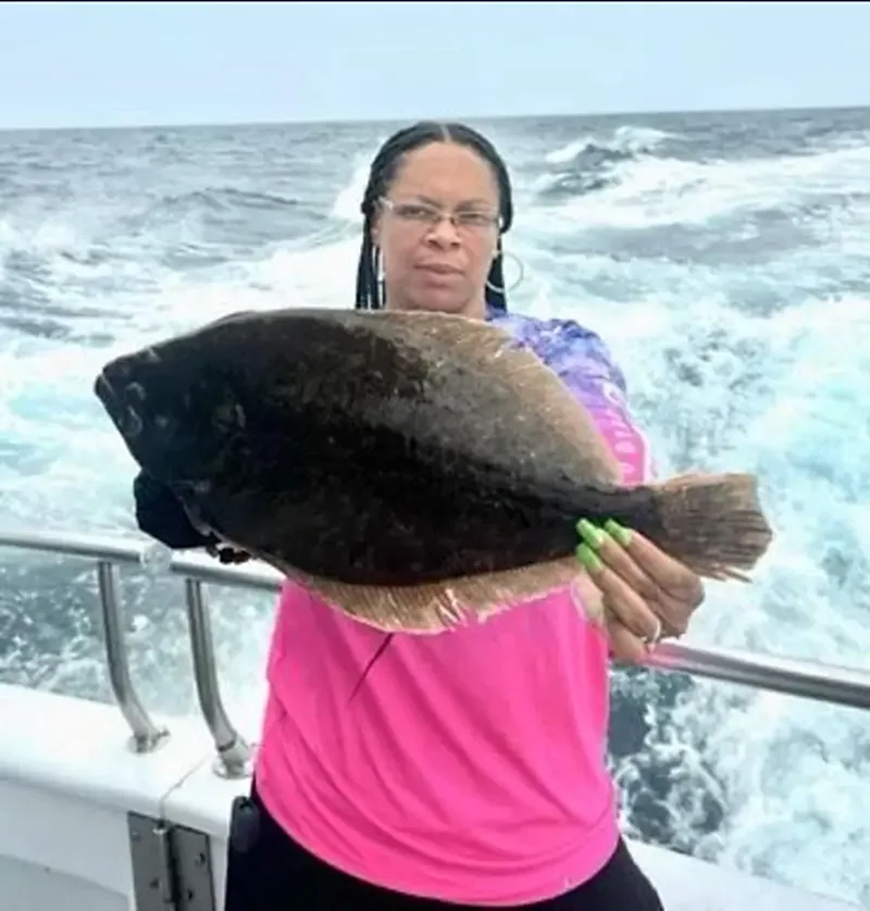a person holding a fish in the water