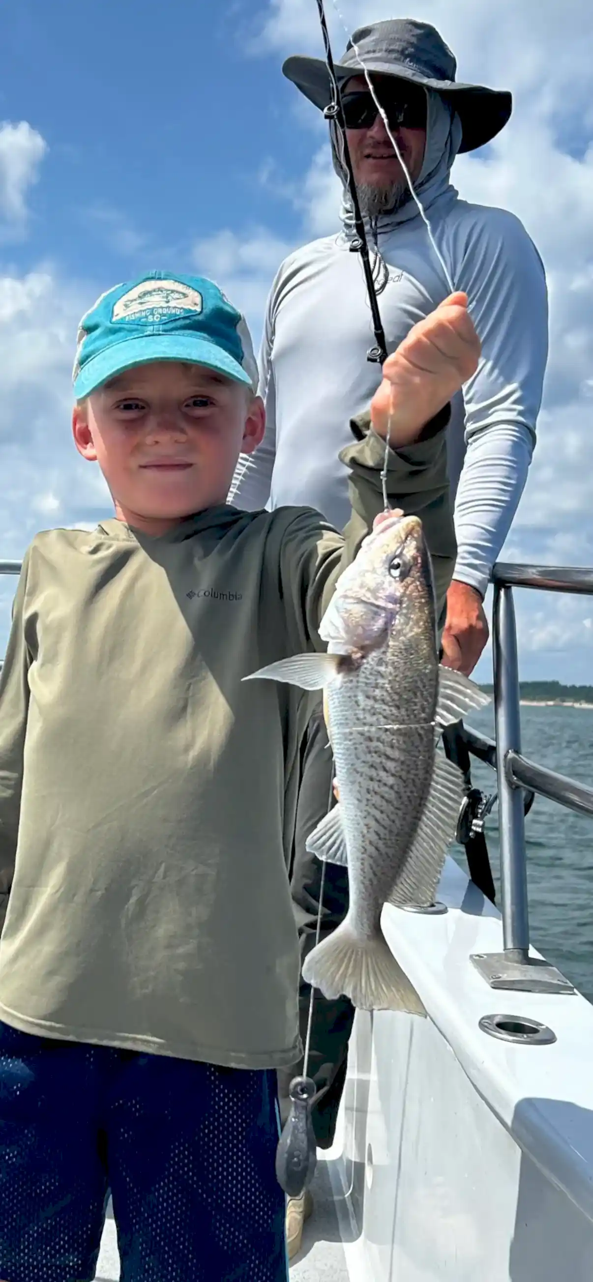 Child catches a very big croaker